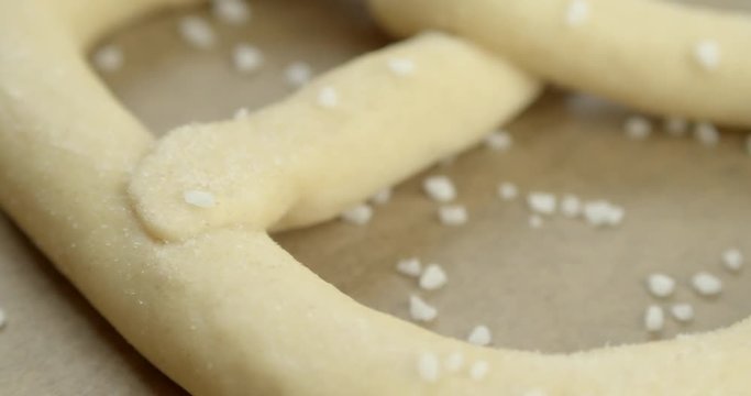 Slow Pan of frozen pretzels waiting for being backed.