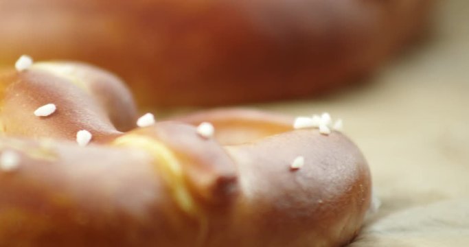 Slow Pan, closeup of salted, baked pretzel.