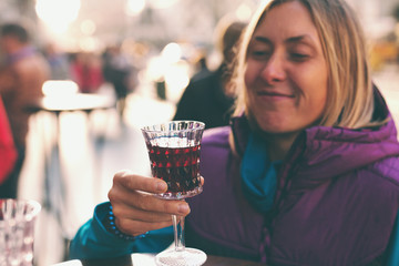 Woman holding a glass of red wine.