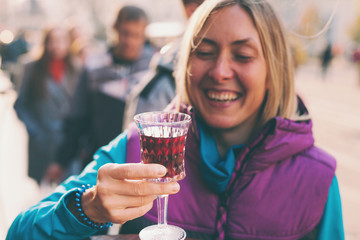 Woman holding a glass of red wine.