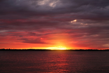Sunset sky with clounds colors in a lake view, soft blurry background, Of free for your space and branding.