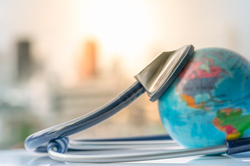 Green Earth day, Save the wold and Global healthcare concept. Stethoscope wrapped around globe on...