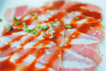 Close up shot pork grilling and bacon on grill plate. Eating Korean BBQ.