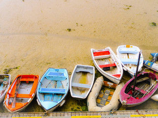 Small old fisher boats on different colors stranded on the beach