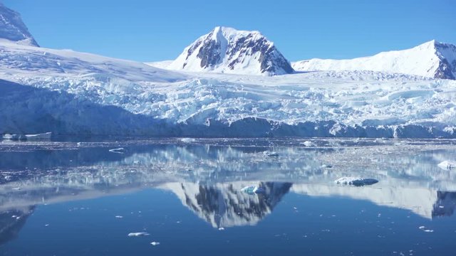Antarctica floating sea ice glaciers and mountains reflections