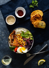 Dinner table buddha bowl Rice chickpeas chicken breast eggs vegetables top view
