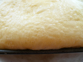 Raw lush dough in bread maker container. Making fresh white bread at home. Healthy cooking concept.  
