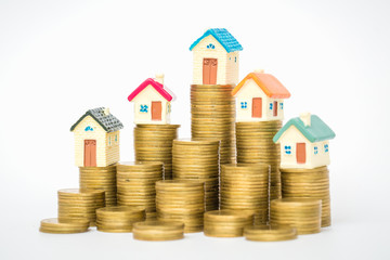 Mini house on stack of coins, isolated on white background, Concept of Investment property.