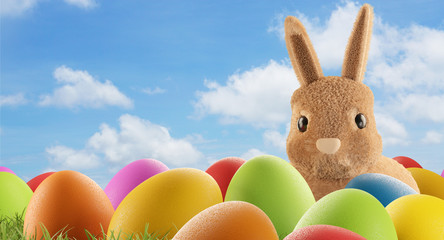 cute Easter bunny with eggs in grass 3d-illustration