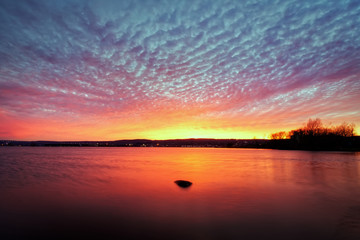 Fantastic Sunset Clouds over Ocean with Reflections