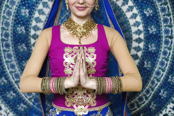 Woman in indian clothes dancing belly dance. Young beautiful woman in national costume dancing tribal dance.