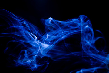 Blue toxic fumes movement on a black background.