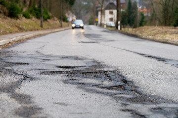 Pothole - Infrastructure degradation. Poor condition of the road surface. Hole in the asphalt
