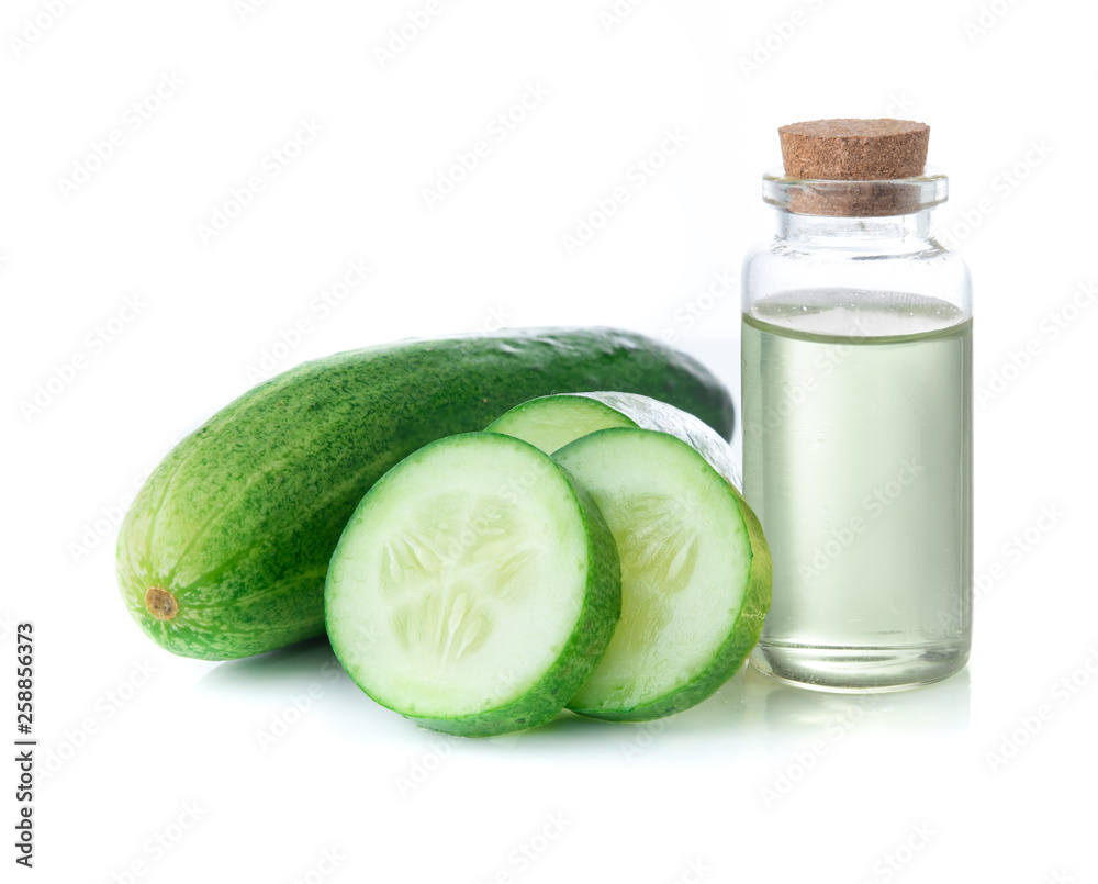 Wall mural Cucumber slices with cucumber essential oil in glass bottle on white background