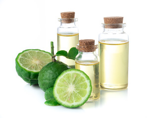 Fresh bergamot fruit and bergamot essential oil in glass bottle on white background