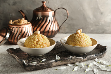 Bowls with traditional Indian food pongal on table