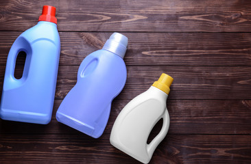 Set of detergents on wooden background