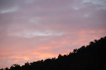 Fototapeta premium Dramatic sunset with soft clouds in orange, pink and blue tones