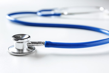 Medical stethoscope on white table