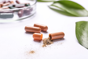 Plant based pills on white background