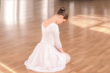 Fototapeta na wymiar Beautiful young ballerina in dance studio