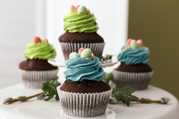 Sweet Easter cupcakes on table