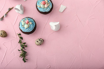 Composition with sweet Easter cupcakes on color background
