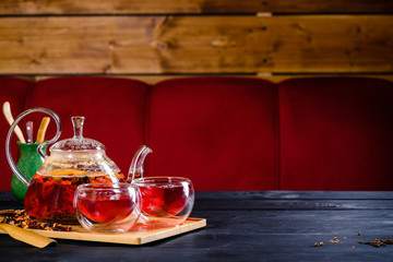 red tea in a glass teapot, tea ceremony