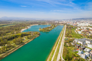 Zagreb, Croatia, Jarun lake, beautiful green recreation park area, sunny spring day, panoramic view from drone, city in background