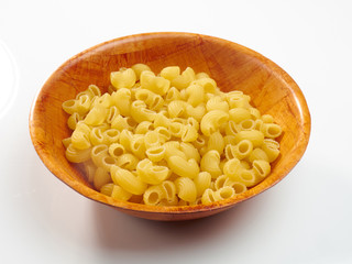 Macaroni a bamboo bowl on a white background
