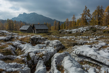 Rocky mountains in the Styrian Alps in Austria with typical huts high in the hills. Autumn mountain landscape.