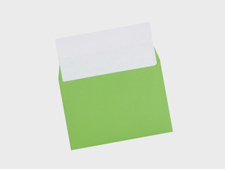 Green envelope with a white sheet of paper on a white background