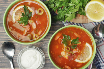 Two bowls with traditional Russian soup solyanka	