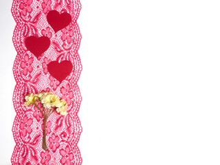 Red lace on a white background with red hearts and flowers