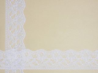 White lace on a beige background