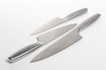 Set of steel kitchen knives on white background