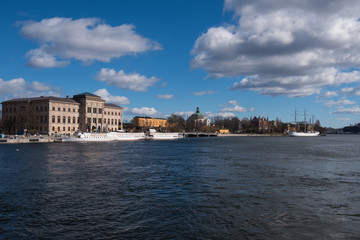 A sunny early spring day in Stockholm, view over a pier with boats and birds at the old town 