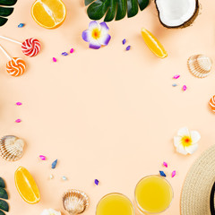 Colorful summer concept flat lay with fresh juice, tropical fruits, lollipops and multicolor seashells, copyspace