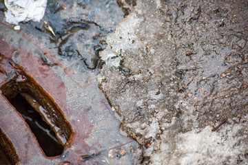 Sewer manhole with melted snow