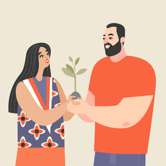 Young couple holding a sapling and smiling. Conceptual image of love and development of relationships
