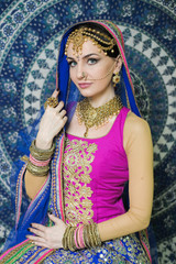 Woman in indian clothes dancing belly dance. Young beautiful woman in national costume dancing tribal dance.