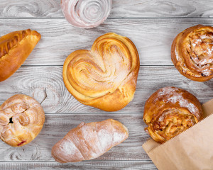 delicious sweet browned cakes bakery products on wooden table.