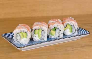 maki roll with raw shrimps, avocado and cream chees