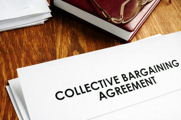 Collective bargaining agreement and note pad with glasses. - obrazy, fototapety, plakaty