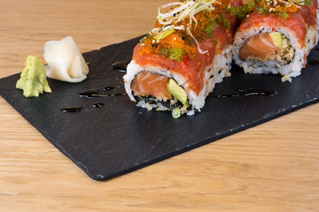 special roll of rice with salmon, avocado, different types of caviar