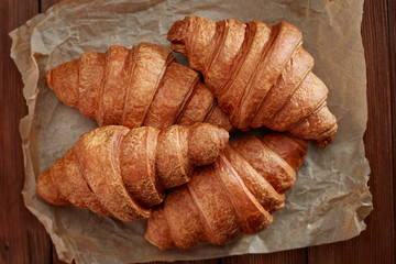 fresh croissants on wooden background
