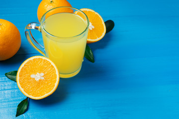 Fresh orange juice or cocktail on blue background