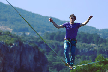Man balancing on the rope concept of risk taking and challenge.