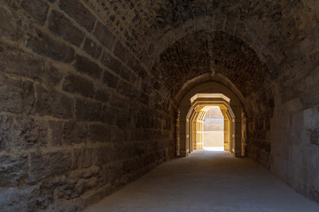Fototapeta premium Mamluk era arched stones tunnel leading to Al-Muayyad Bimaristan (ancient hospital), Darb El Labbana district, Cairo, Egypt