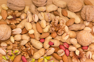 Background of the various nuts on a wooden surface